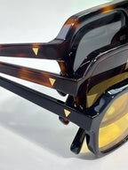 Tortoiseshell and black eyeglass frames with clear lenses