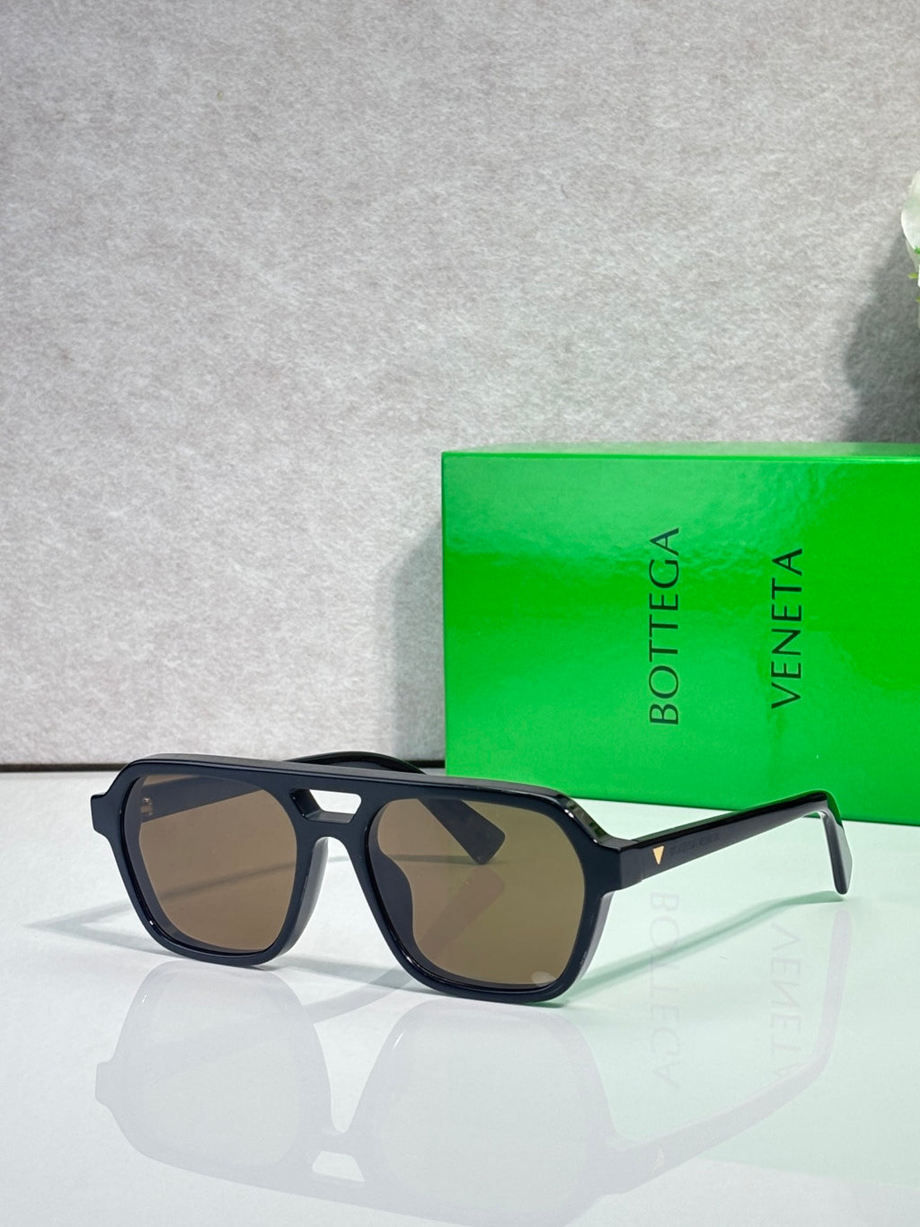 Sunglasses with warm brown lenses and black tortoiseshell frames