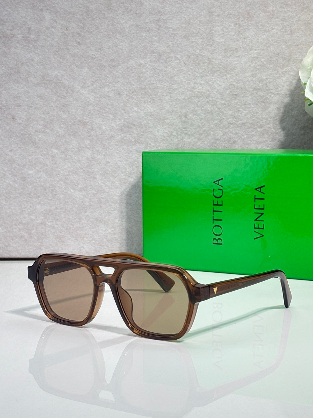 Sunglasses with brown lenses and tortoiseshell frames, side profile