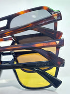 Sunglasses close-up with tortoiseshell temples and yellow-tinted lenses