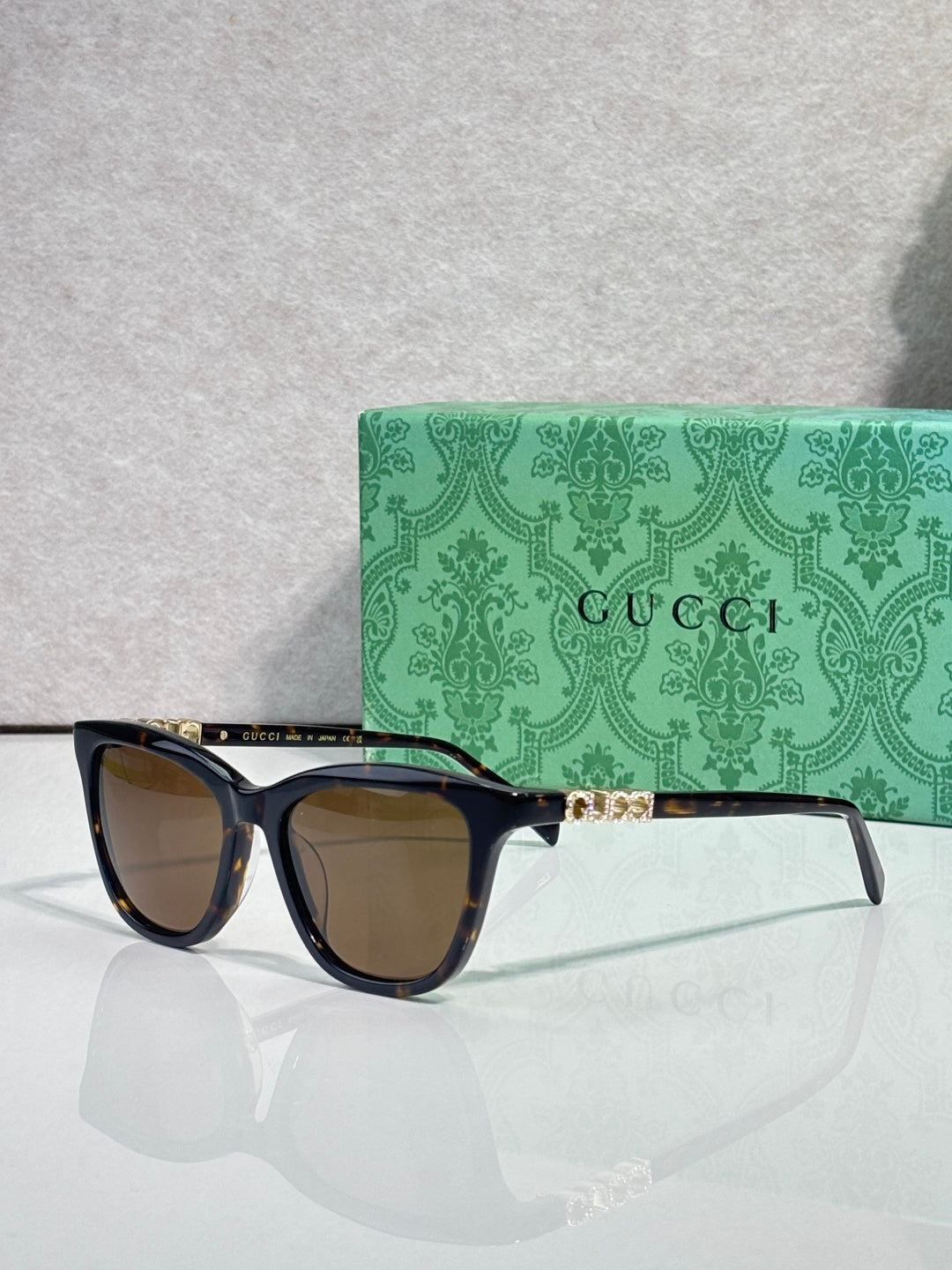 Gucci cat-eye sunglasses with dark frames and brown-tinted lenses
