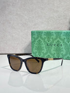 Gucci cat-eye sunglasses with dark tortoiseshell frames and brown lenses