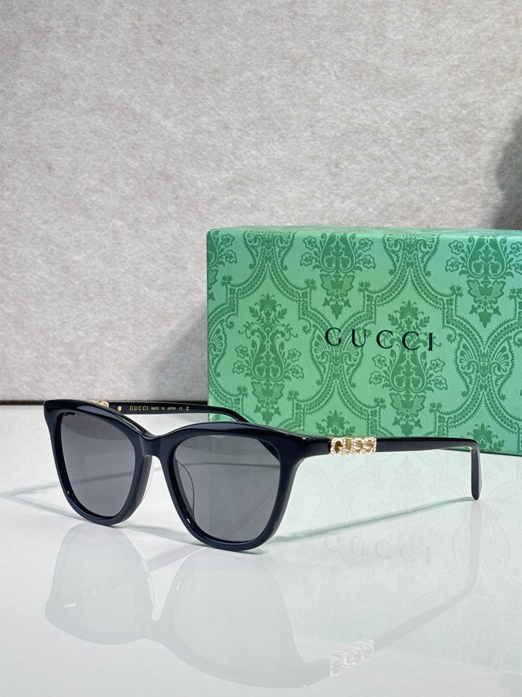 Gucci cat-eye sunglasses, navy frames with smoke lenses, front view