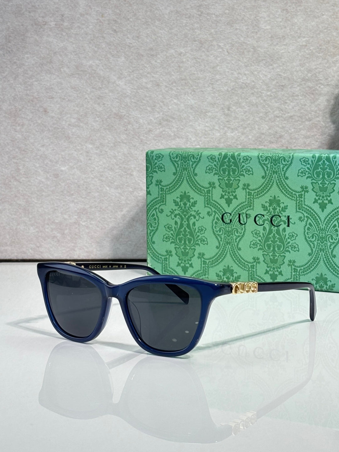 Gucci cat-eye sunglasses with navy frames and dark lenses
