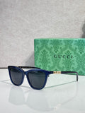 Gucci cat-eye sunglasses with blue acetate frames and dark lenses