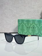 Gucci cat-eye sunglasses with black frames and dark lenses