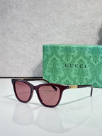 Gucci cat-eye sunglasses with maroon frames and rose-tinted lenses