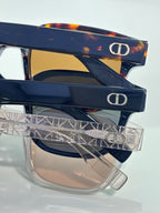 Navy sunglasses with tinted lenses and clear temple design