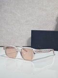 Silver sunglasses with pink-tinted lenses and geometric temple detailing