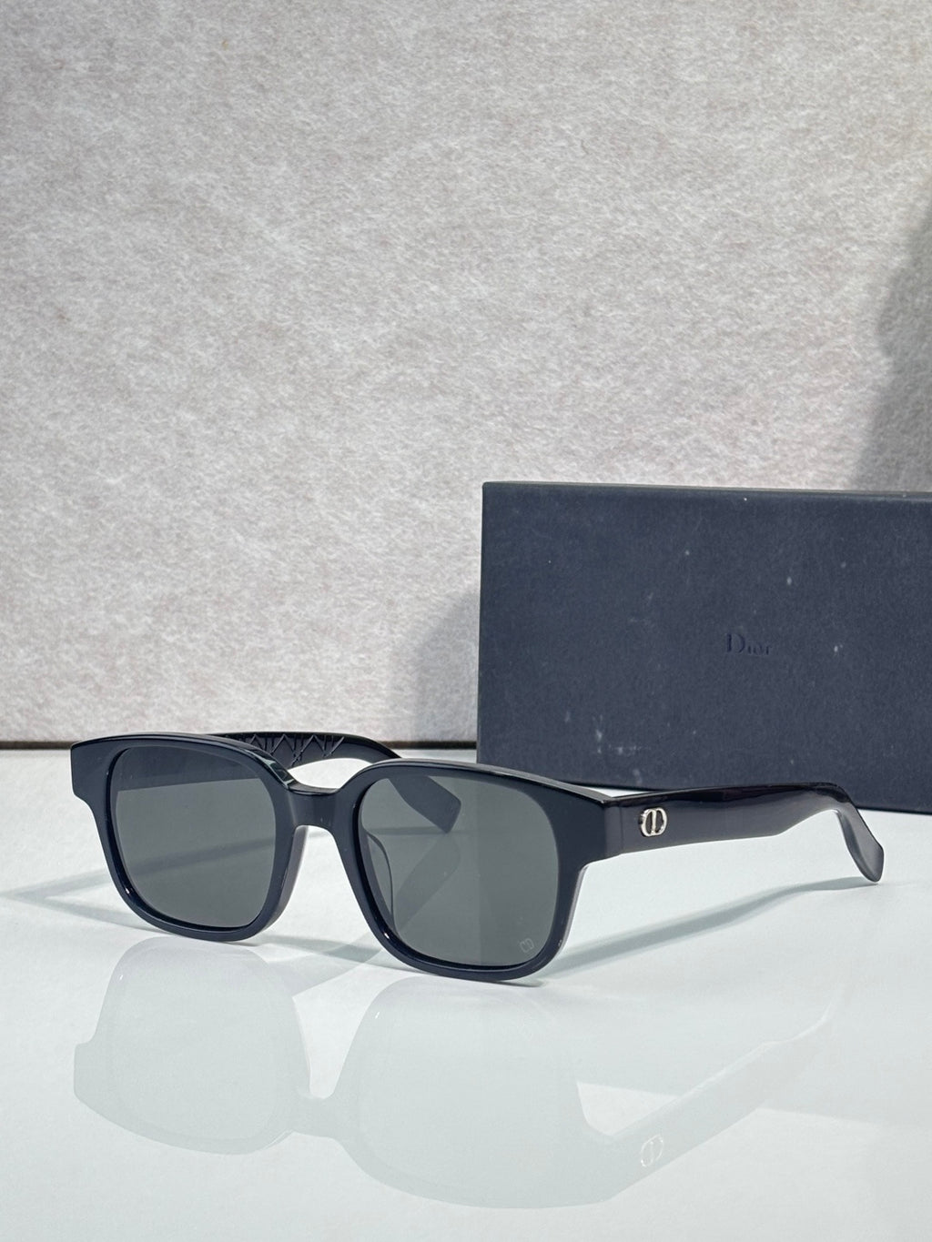 Black sunglasses with dark lenses and slim logo temple detail