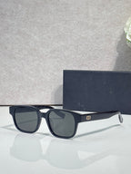 Navy sunglasses with dark lenses and curved temple profile