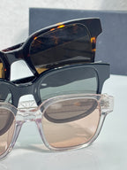 Blue and clear sunglasses with tinted lenses, stacked with temple logos visible