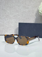 Dior tortoiseshell sunglasses with dark lenses and gold-tone hinges