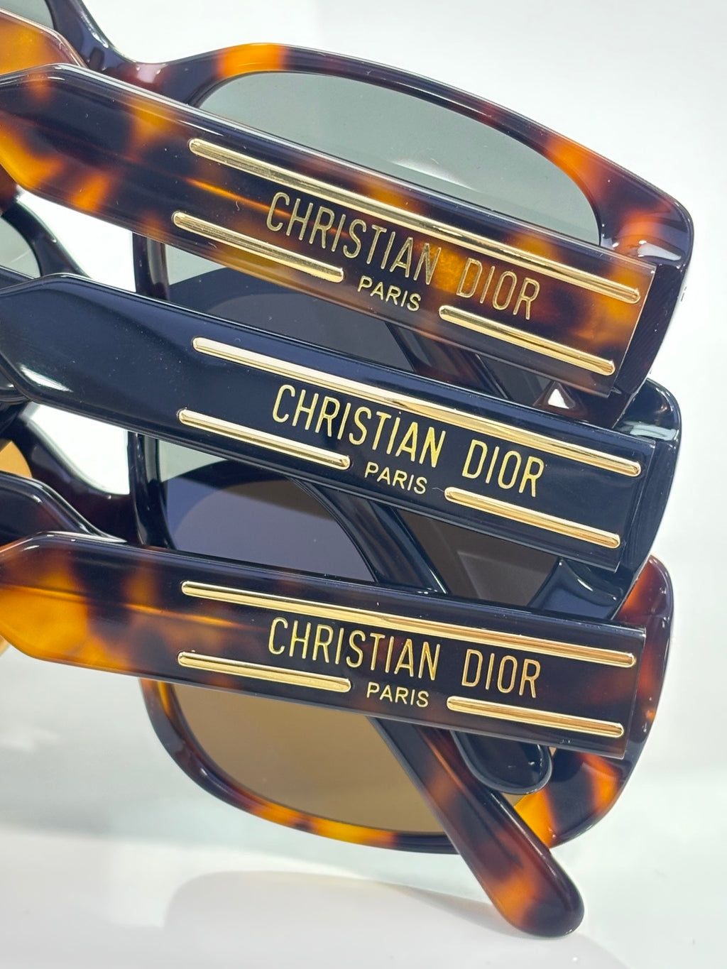 Tortoiseshell sunglasses temples with Christian Dior Paris logo text