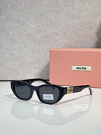 MiuMiu eyeglasses with dark acetate frames and dark lenses, beside a pink case