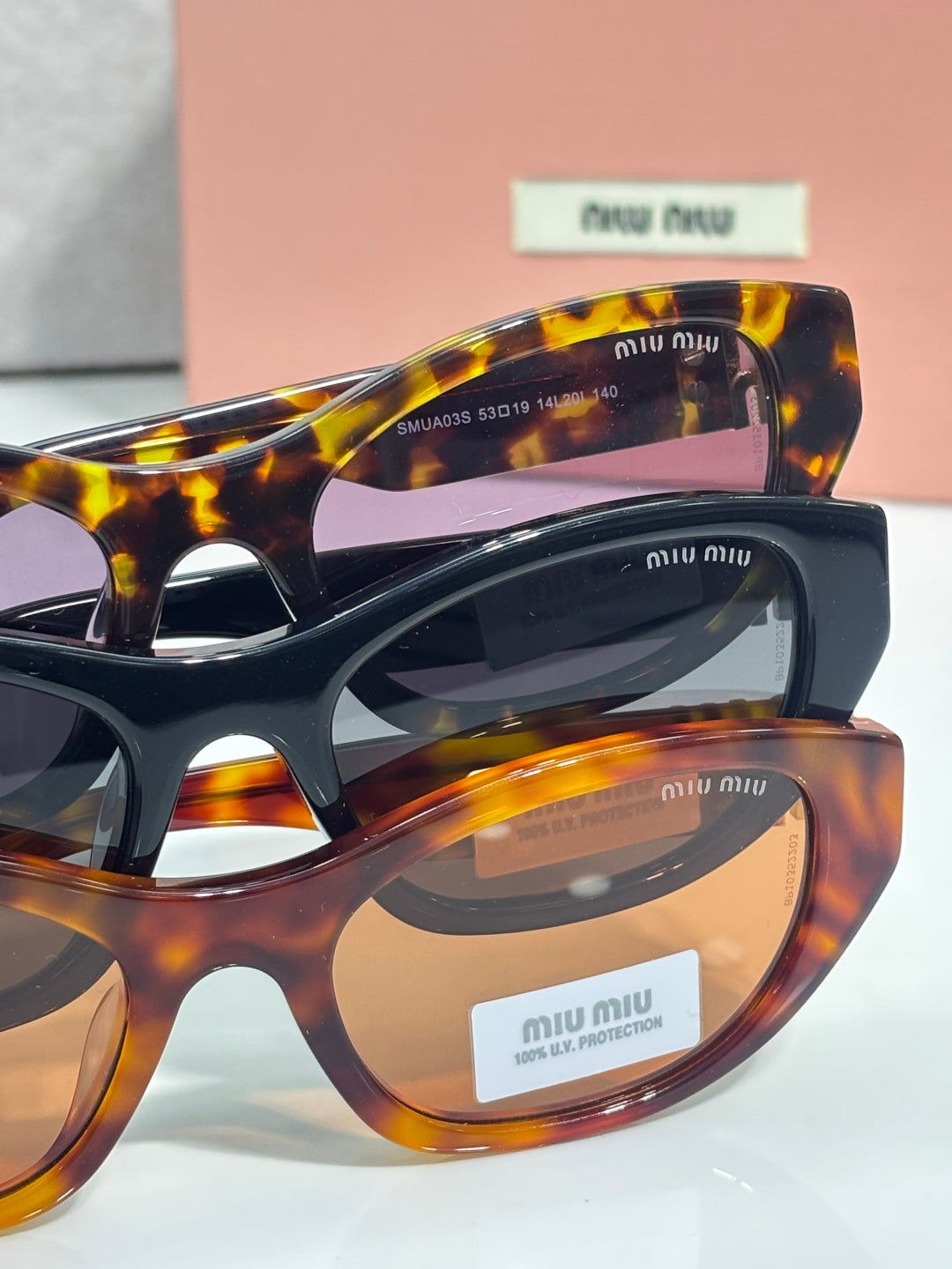 MiuMiu eyeglasses side view with tortoiseshell frame and gold-tone logo on temple
