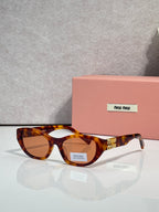 MiuMiu eyeglasses with warm tortoiseshell acetate frames and amber-tinted lenses