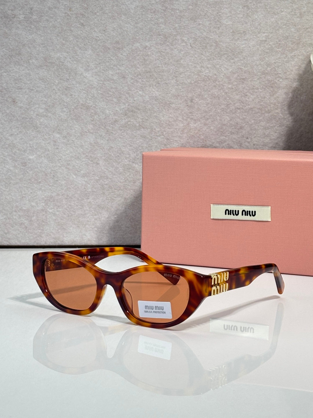 MiuMiu eyeglasses with warm tortoiseshell acetate frames and amber-tinted lenses