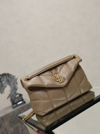 YSL quilted beige bag on display, with top flap and gold chain strap