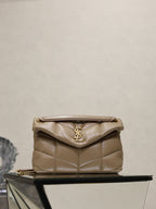 YSL quilted beige bag with flap, YSL logo, and gold chain strap