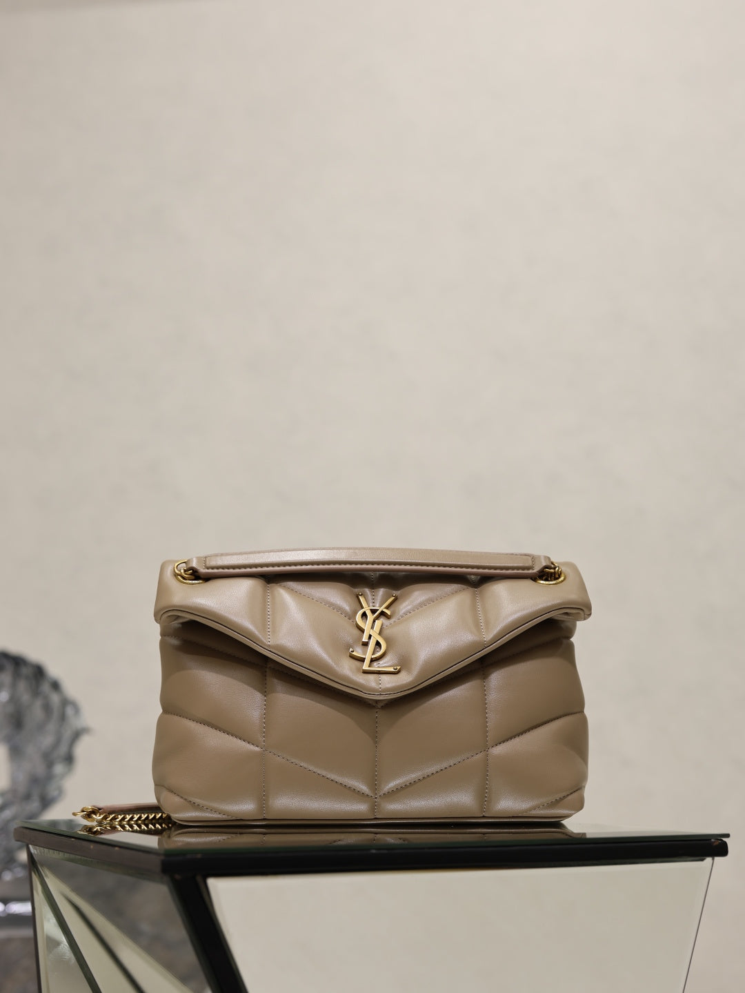 YSL quilted beige bag with flap, YSL logo, and gold chain strap