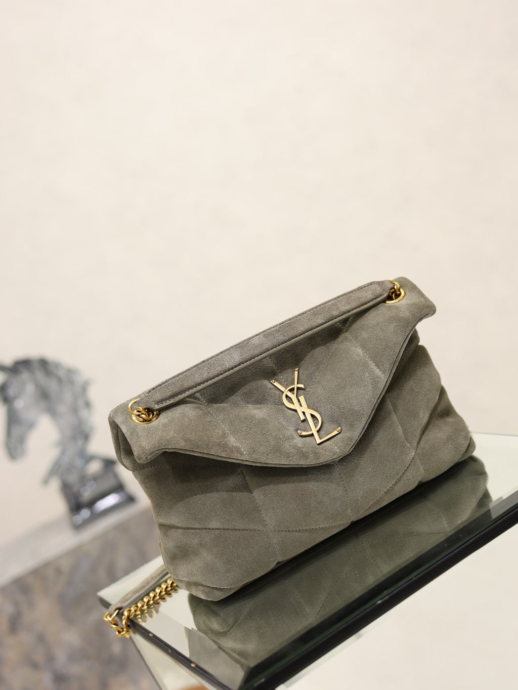 Gray YSL shoulder bag with curved flap and YSL logo, gold chain strap