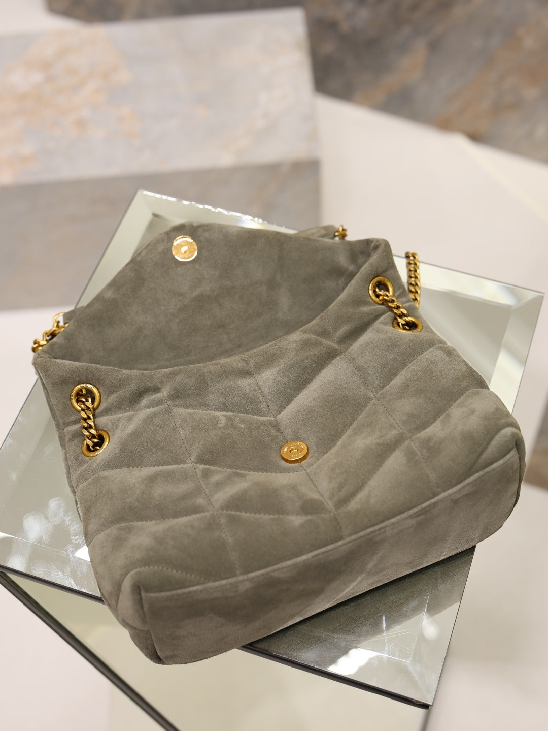 Gray YSL shoulder bag top view with snap buttons and gold chain strap