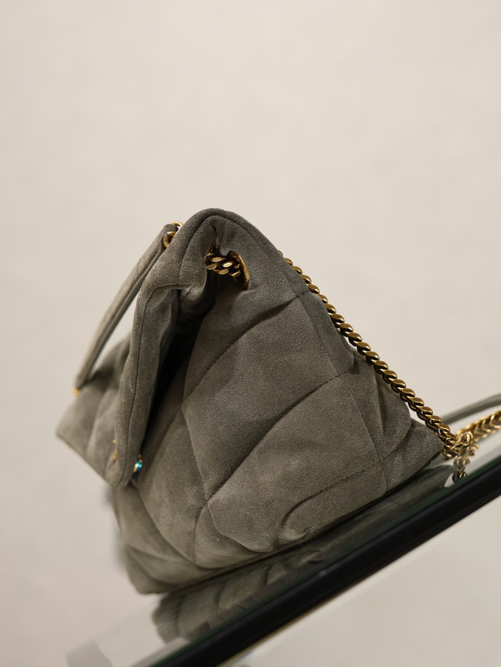Gray YSL quilted shoulder bag with gold chain strap and clasp, dark lining