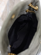 Black YSL shoulder bag with gathered fabric and gold chain strap, open top