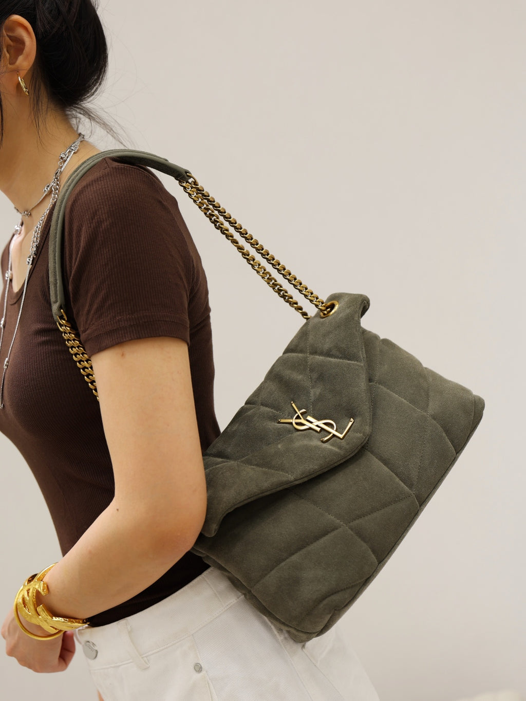 Gray quilted shoulder bag with envelope flap, gold YSL mark, and long chain strap