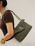Gray quilted shoulder bag with envelope flap, gold YSL mark, and long chain strap