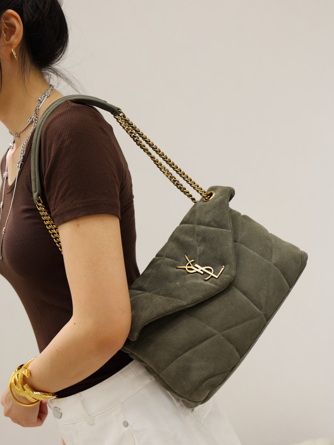Gray quilted shoulder bag with envelope flap, gold YSL mark, and long chain strap