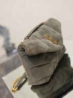Gray suede shoulder bag with quilted sides, gold chain strap, clasp hardware