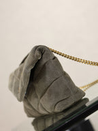 Gray suede shoulder bag corner with folded flap and gold chain strap