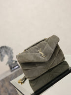 Gray suede shoulder bag with quilted flap, gold YSL logo, front 3/4 on chain