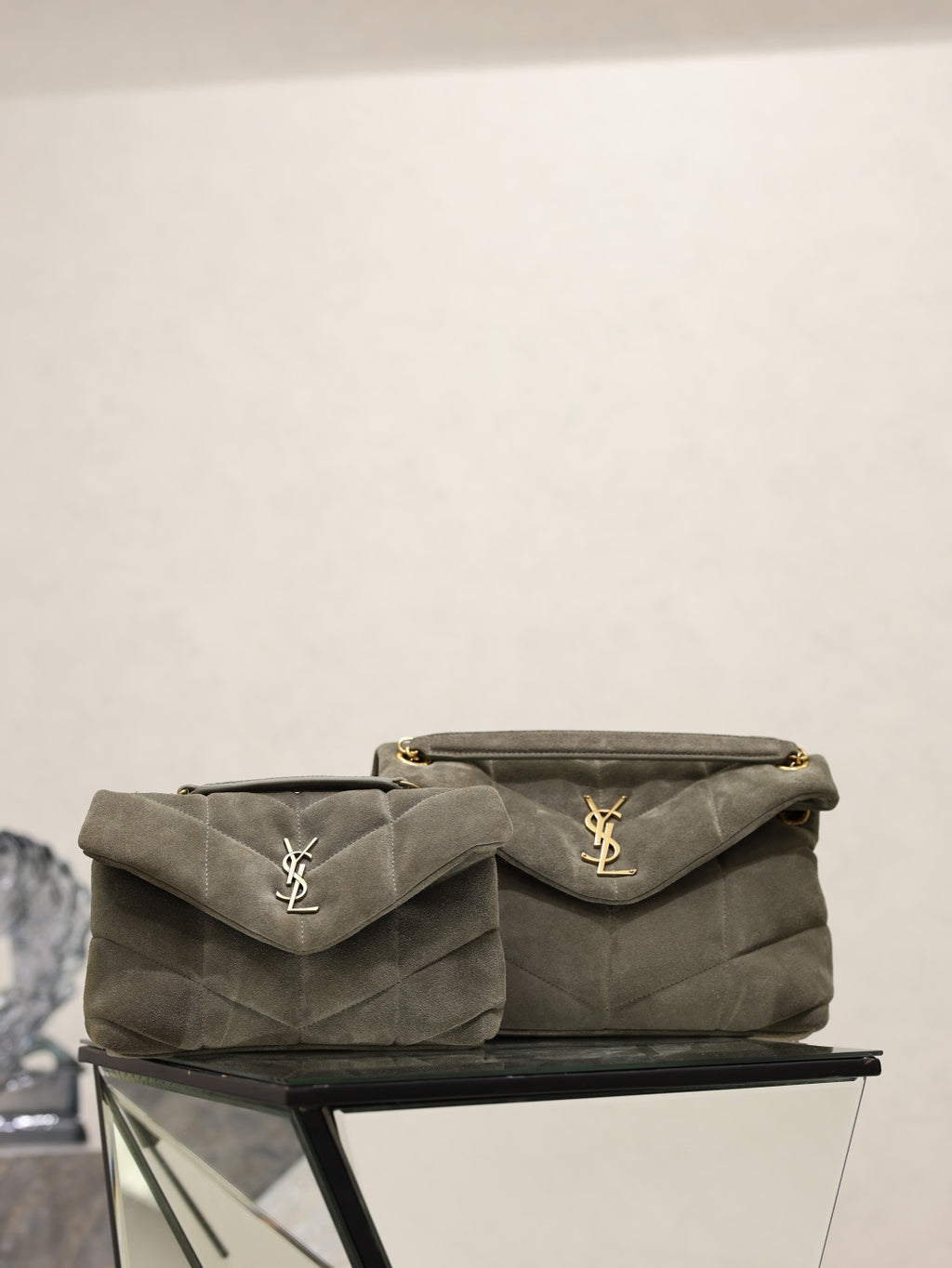 Quilted gray shoulder bag with flap, gold YSL logo, and chain strap