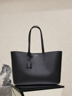 YSL black leather tote bag with top handles and hanging charm