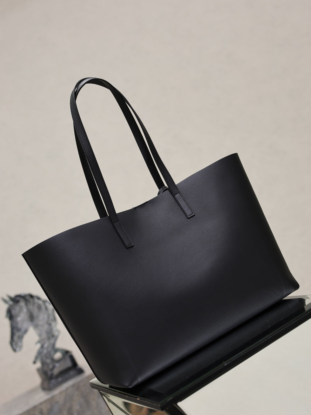 YSL black leather tote bag with two top handles and minimal branding