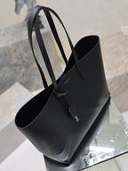 YSL black leather tote bag with top handles and open interior view
