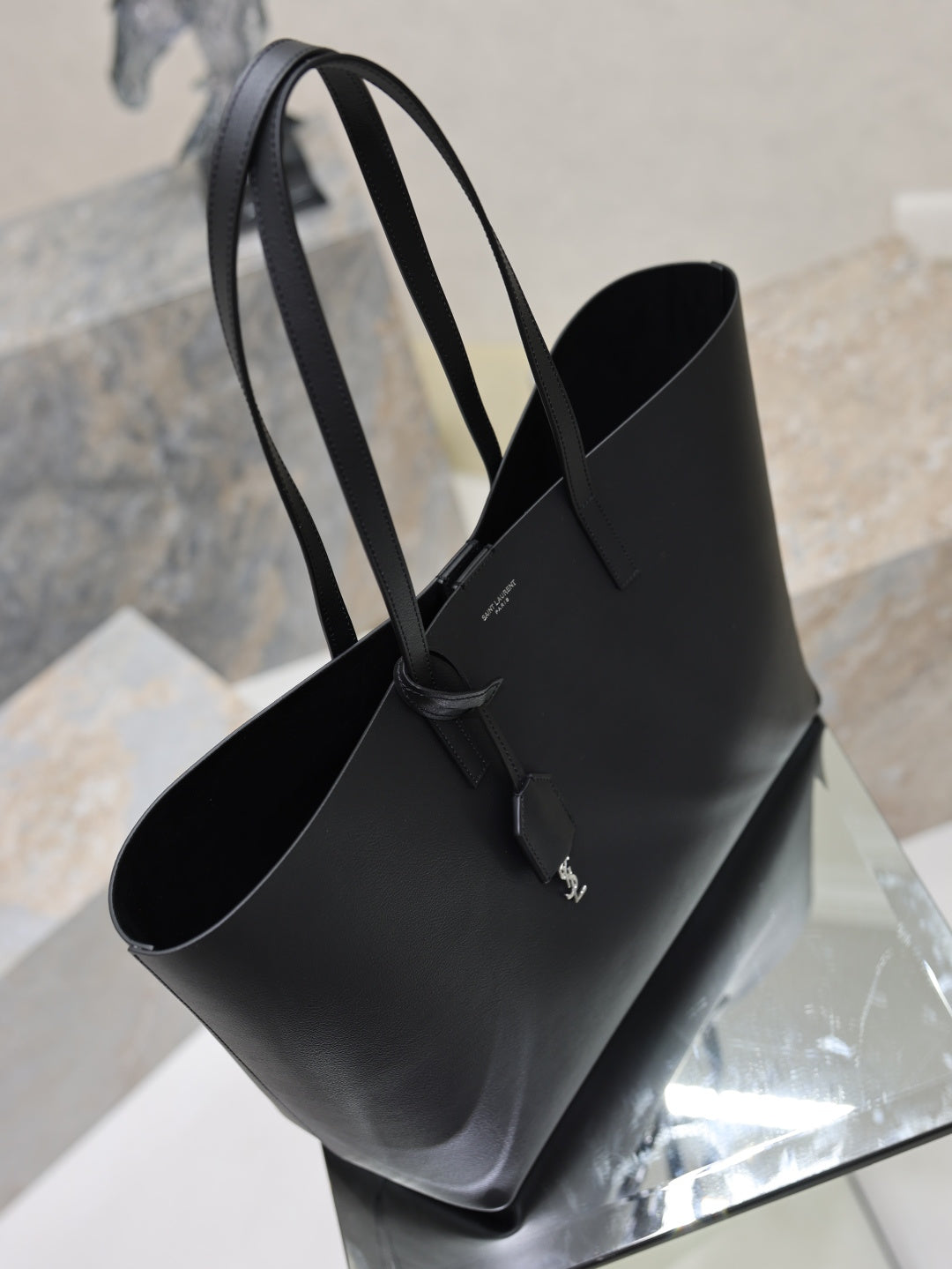 YSL black leather tote bag with top handles and open interior view