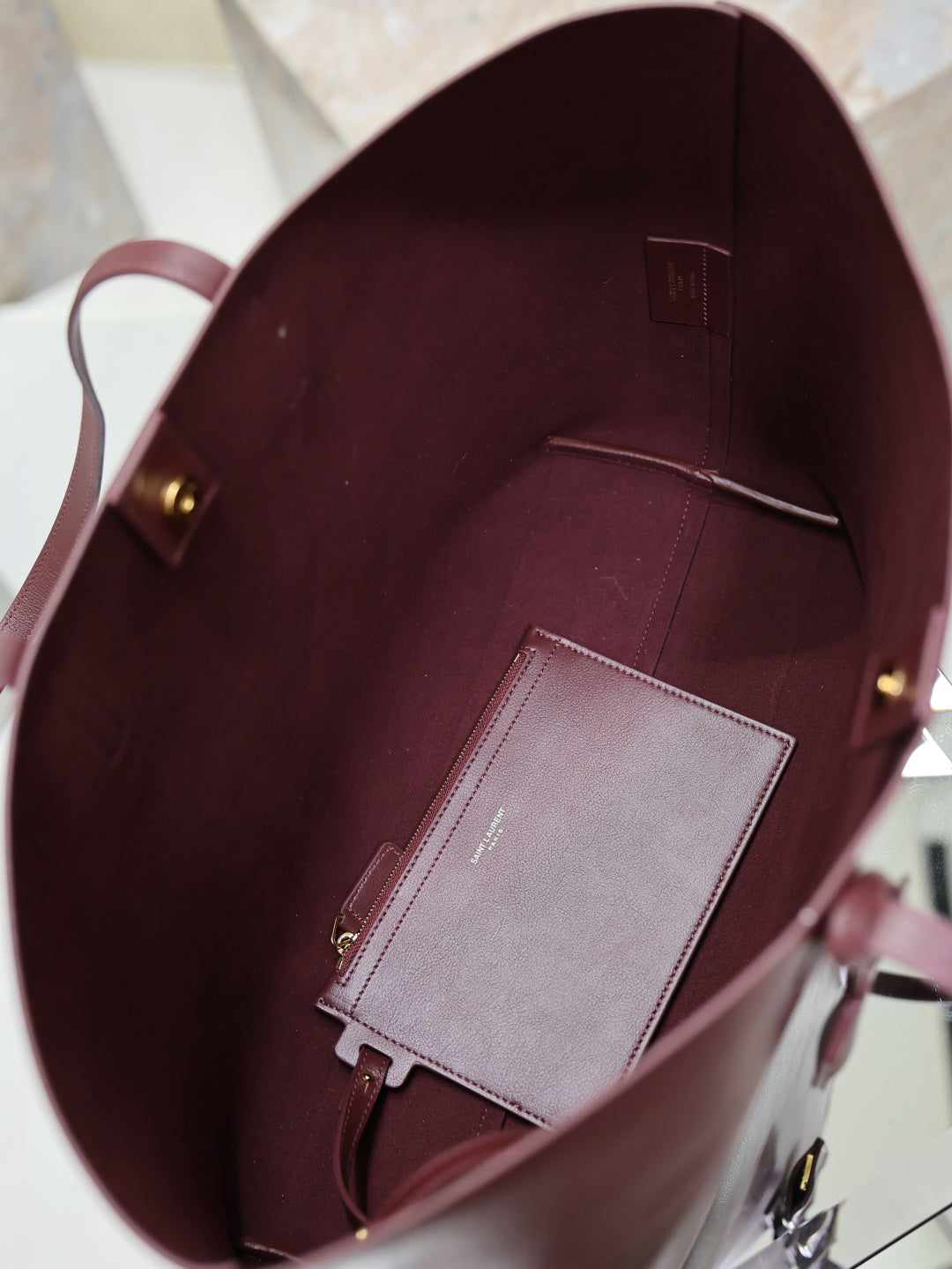 YSL burgundy tote bag interior view with pocket and gray card holder