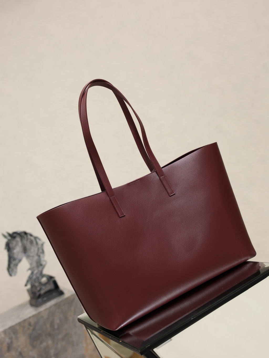 YSL burgundy tote bag front view with twin top handles and minimal branding