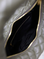 Inside view of quilted hobo bag with black lining and zippered pocket