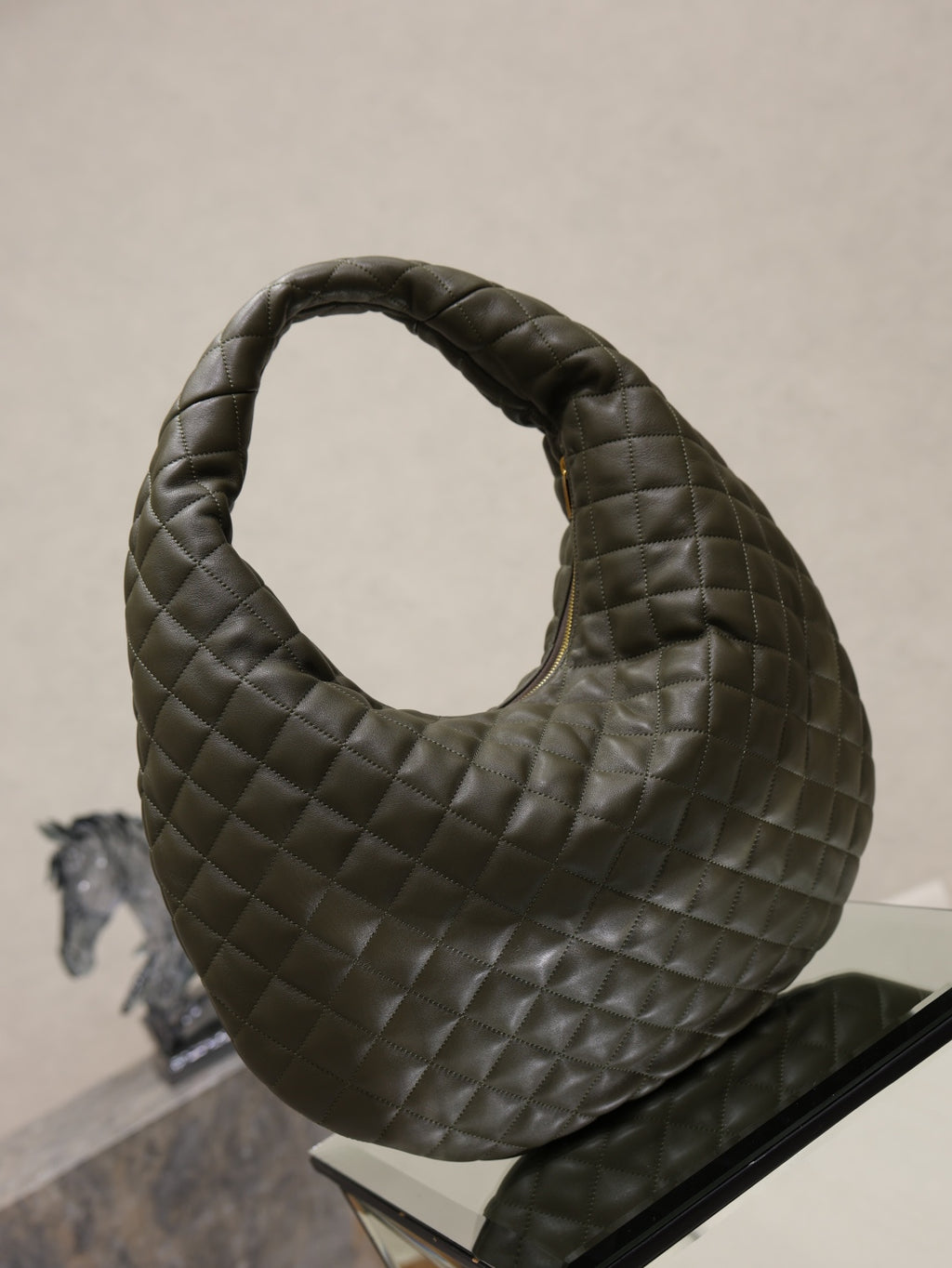 Quilted hobo shoulder bag with top opening and dark olive leather finish