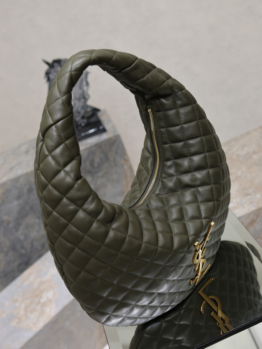 Quilted hobo shoulder bag with front zipper opening and gold hardware