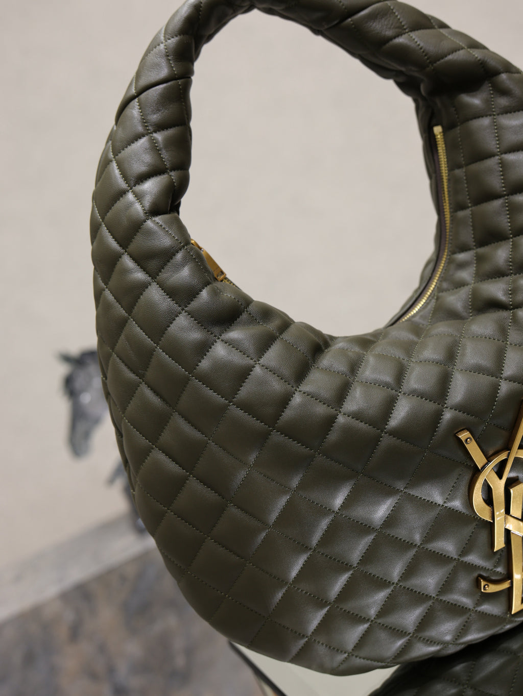 Quilted hobo shoulder bag with curved handle and gold YSL logo hardware