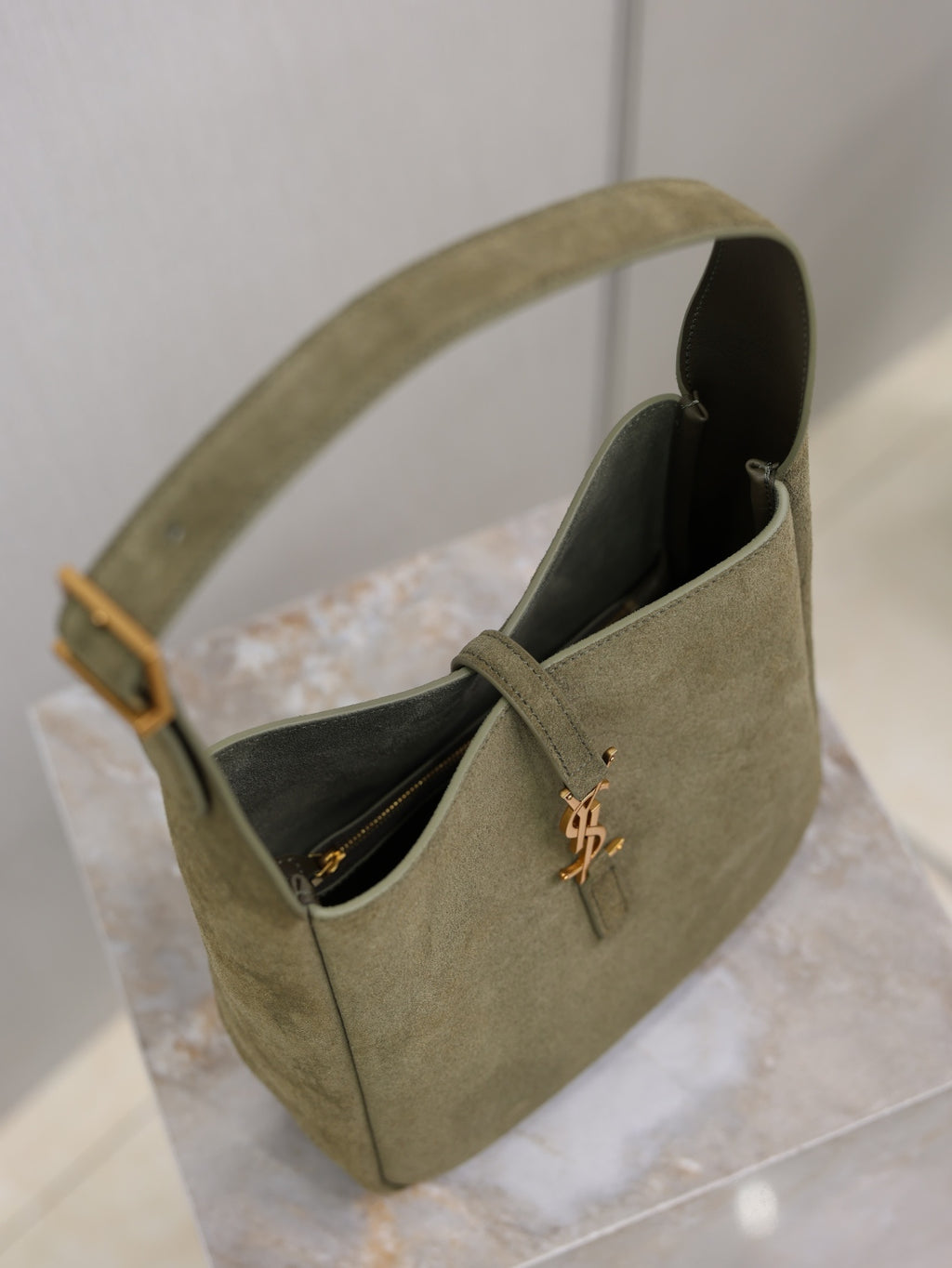 YSL bag in olive suede with open top and black interior lining