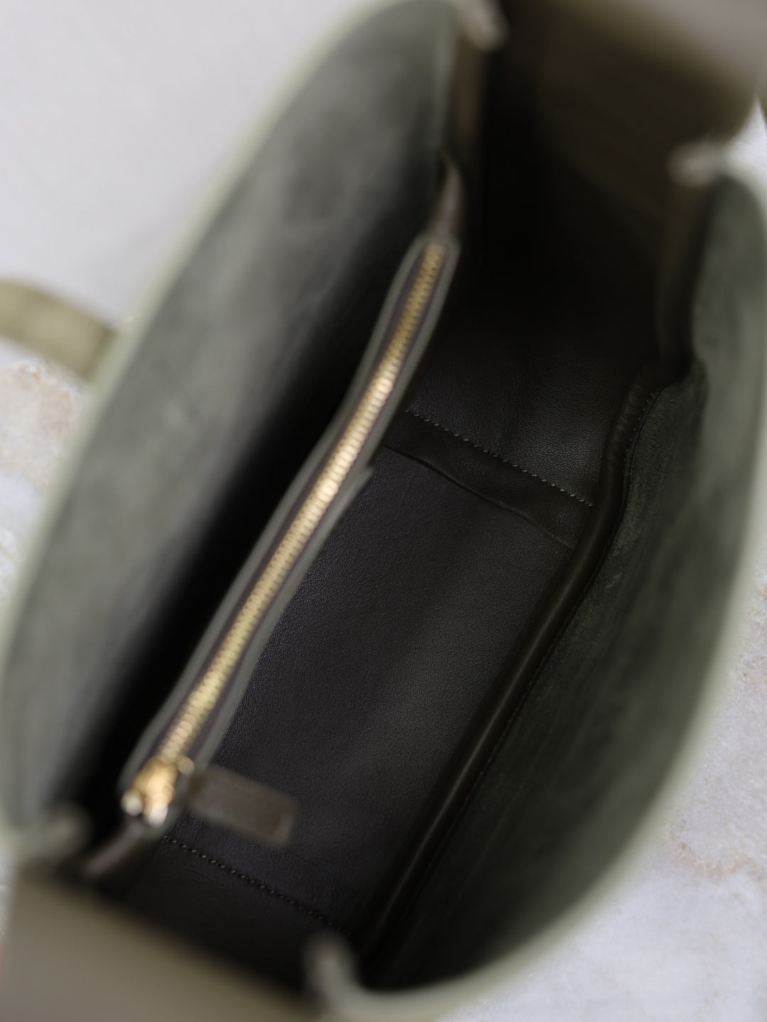 YSL bag interior with black lining and visible gold-tone zipper hardware