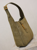 YSL bag in olive suede with top handle, side seam, and front zipper pull