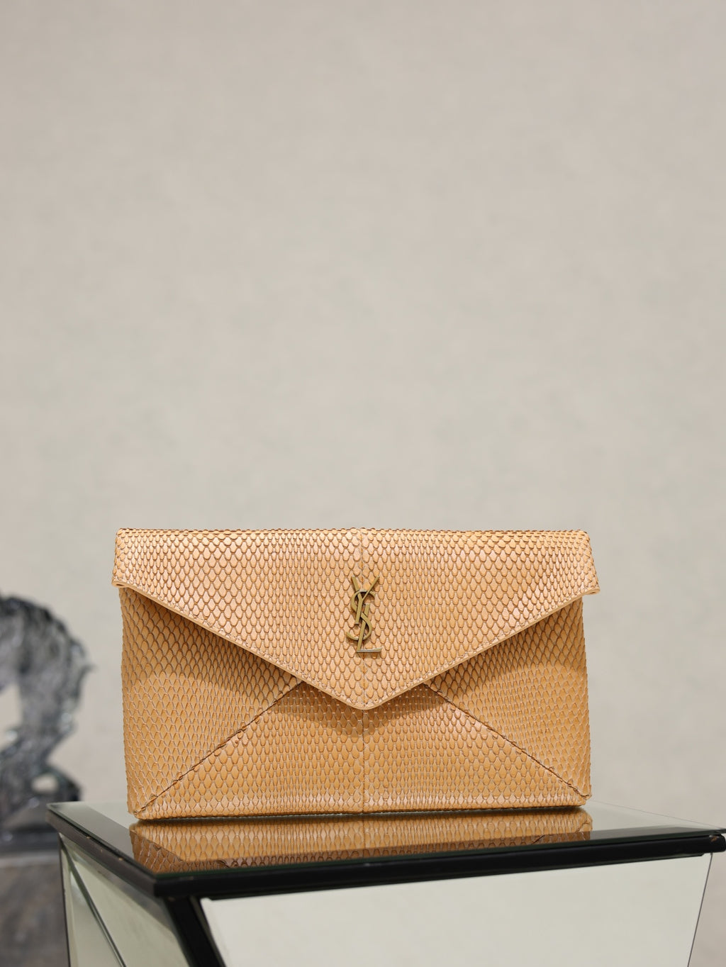 YSL envelope clutch bag with textured finish and fold-over flap, gold logo